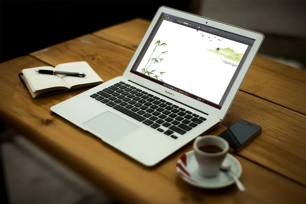 Ordinateur portable affichant une illustration vectorielle zen, sur un bureau en bois avec carnet et tasse de café